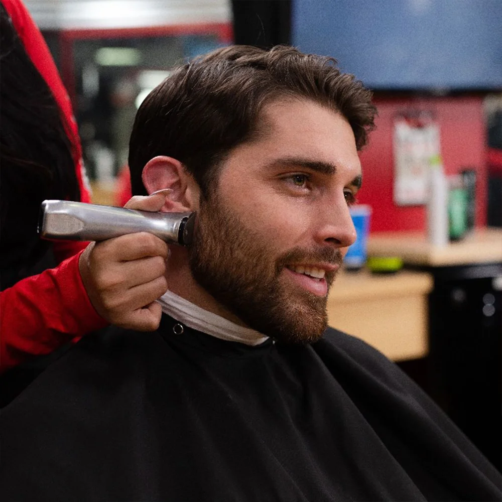 beard man getting his beard trimmed